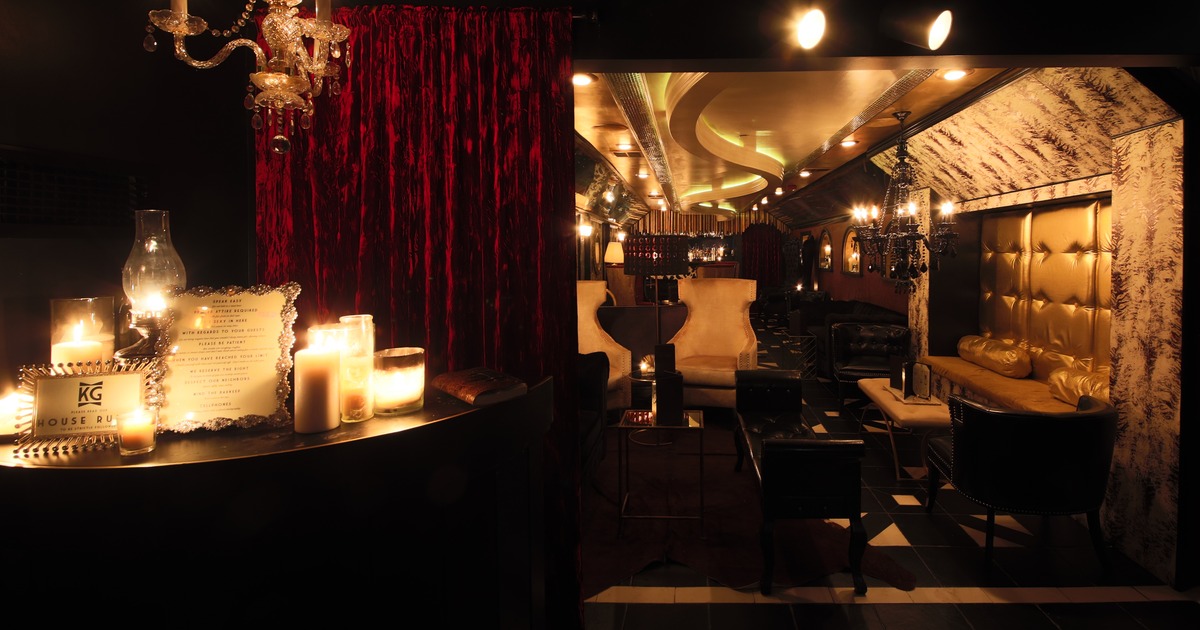 Lounge area, desk with candels, lamps, and House Rules signs