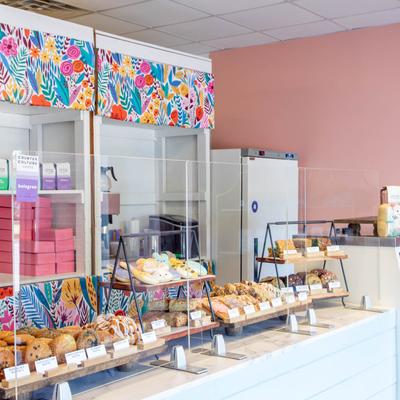 Colorful interior with various baked goods on display.