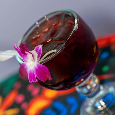 Jamaican hibiscus drink garnished with a flower.