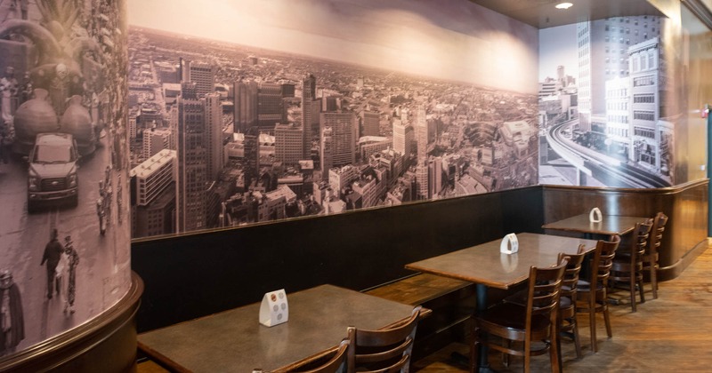 Interior, seating and tables by a wall decorated with a large black and white photo print
