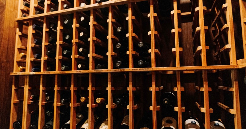 A wooden wine rack filled with bottles