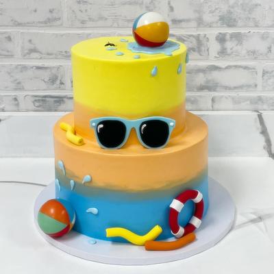 Pool party cake, decorated with summer and pool-themed elements.