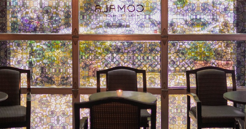 Interior, tables and chairs next to the windows