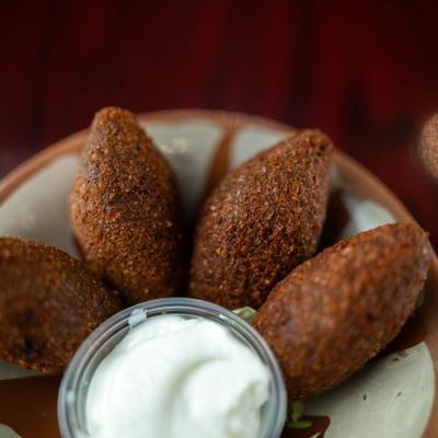 Kibbeh balls with yoghurt dipping sauce.