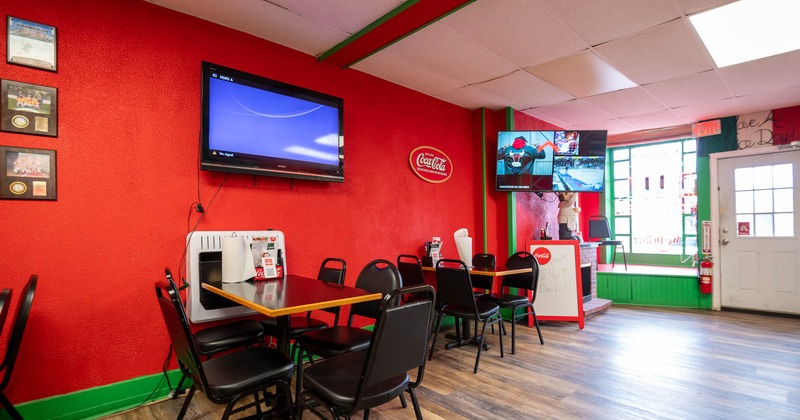 Interior seating area with two TV screens on the wall