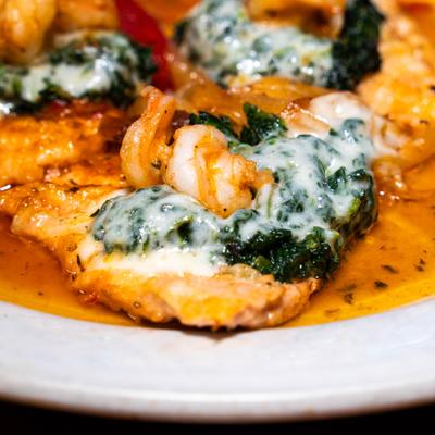 Chicken with spinach, mozzarella cheese and shrimp in a wine sauce.