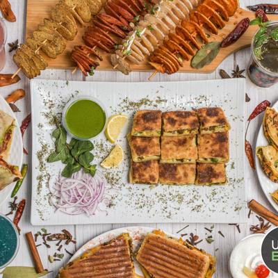 Assortment of dishes from Shaikh's Cafe spread on a table.