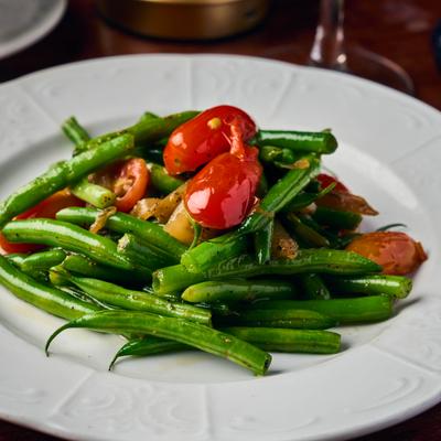 Green beans tossed with tomatoes and mushrooms.