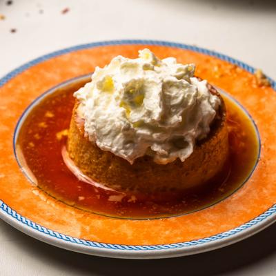 Custard dessert with caramel sauce and whipped cream.