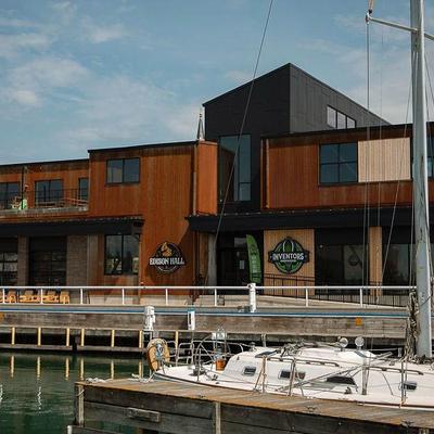 Waterfront building exterior with docked boats.