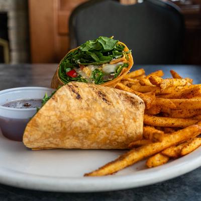 Spinach wrap with French fries and hot bacon dressing.