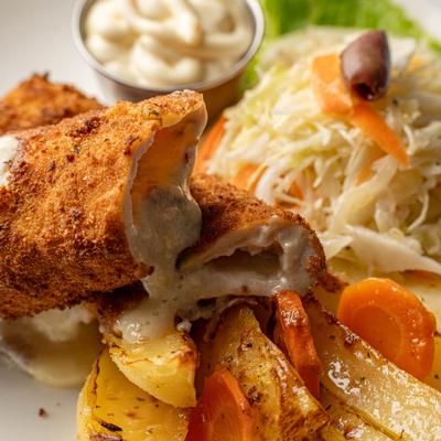 Crispy fried stuffed roll with creamy filling, roasted potatoes, carrots, and cabbage slaw.