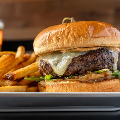 Cheeseburger served alongside golden fries.