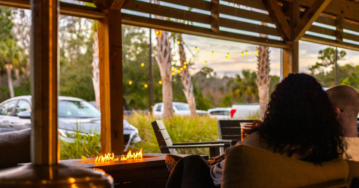 A cozy outdoor patio featuring a fire pit table that provides warmth and ambiance
