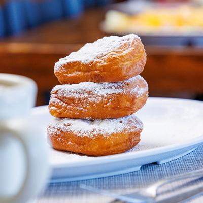 Three stacked beignets.