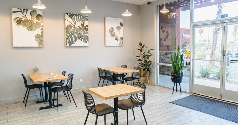 Restaurant interior - table, two chairs, pictures on the wall