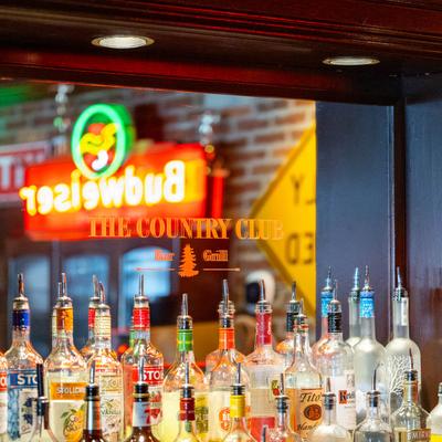 Assorted vodka bottles on a bar shelf.