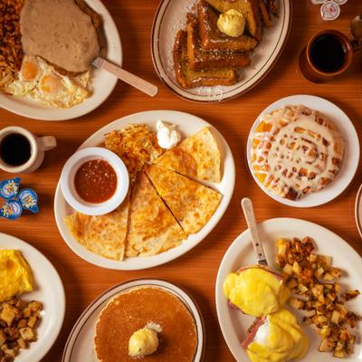 Assortment of dishes served on the table with drinks and condiments.