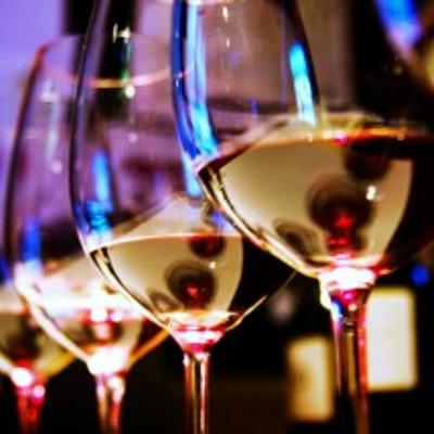 Wine glasses displayed under warm ambient lighting on a table.