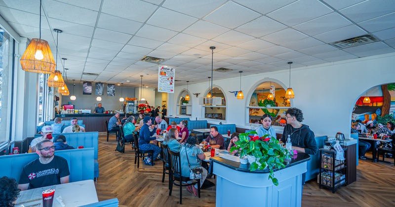 Spacious and cozy interior dining area full of guests