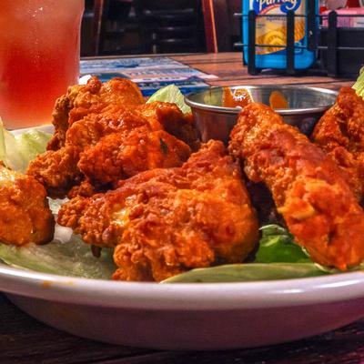Mexican Spicy Wings served over lettuce with a dip on the side.
