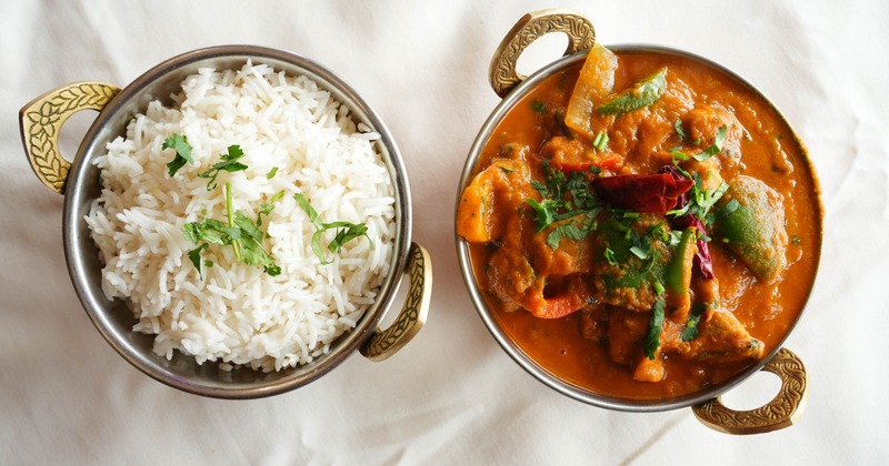 Chicken Karahi served with a side of rice, overhead view