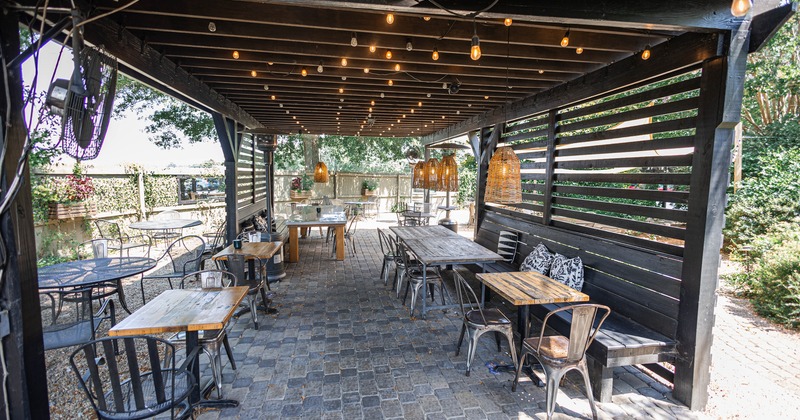 Exterior, patio,tables, benches, chairs in  wooden awning shade