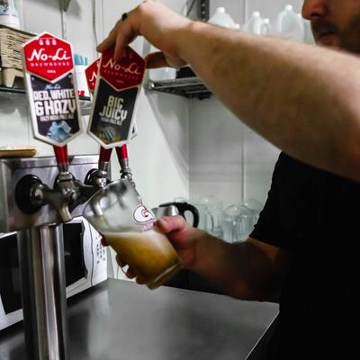 Bartender pouring beer from the tap.