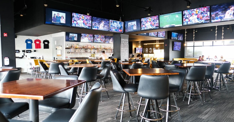 Interior, tables and chairs, tv screens on the walls