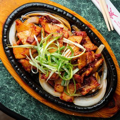 Spicy stir-fried pork with onions, top view.