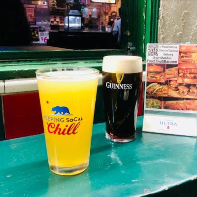 Two glasses of beer served on the table alongside table tent menu.