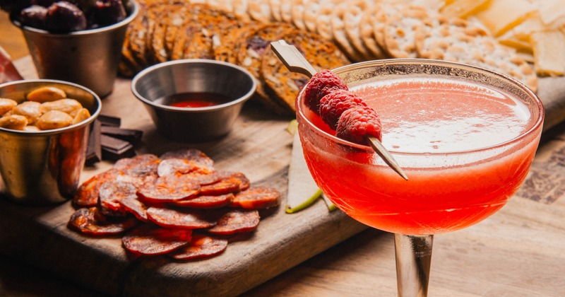 Raspberry cocktail paired with charcuterie board