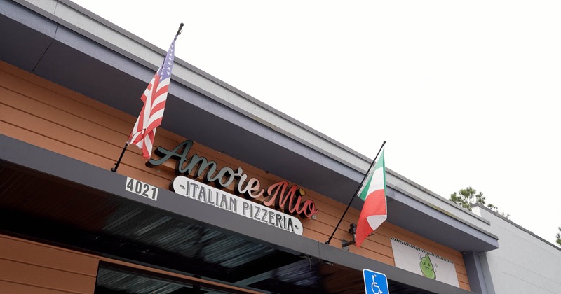 Restaurant's outdoor signage with American and Italian flags