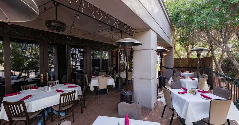 Patio with set tables and heaters