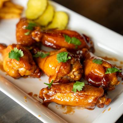 Portion of wings with fres herbs as a garnish.