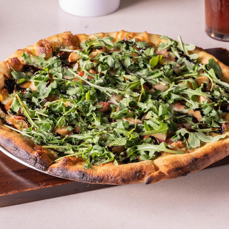 Burrata, prosciutto, and arugula pizza photo