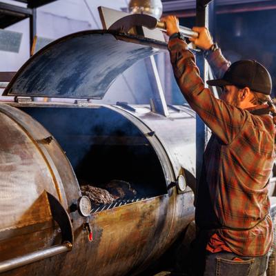 Employee working a smoker