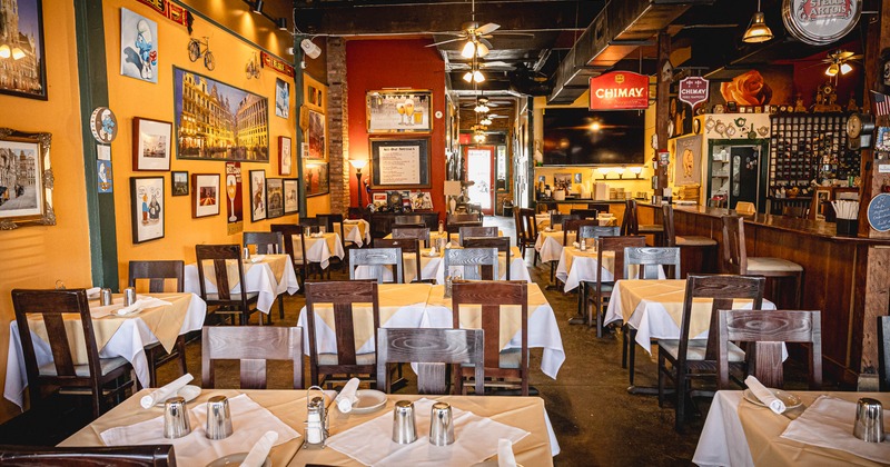 A Belgian-themed restaurant interior with wooden tables and chairs