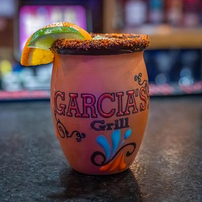 Cantarito cocktail with lime and orange garnish.