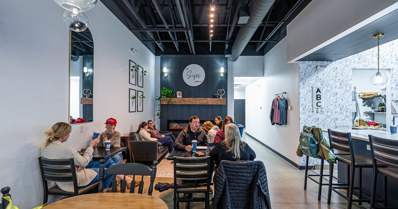People seated at tables in a modern cafe