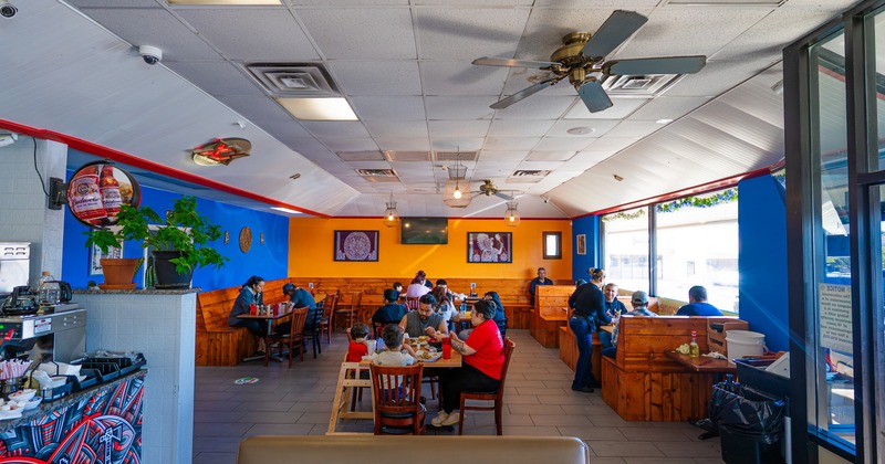 Interior, dining space with wooden tables, benches and chairs