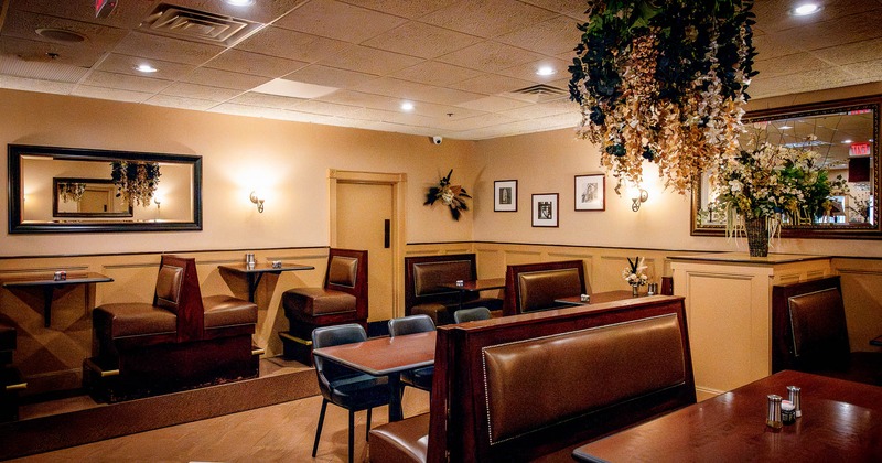 Dining area, tables, chairs  and restaurant booths with mirrors on the wall