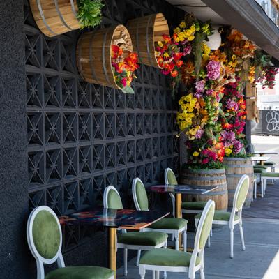 Exterior, floral decor at the entrance and a seating area.