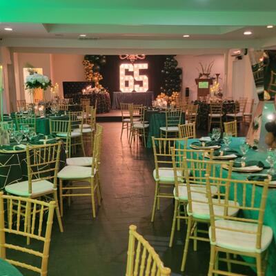 Dining tables with green tablecloth.