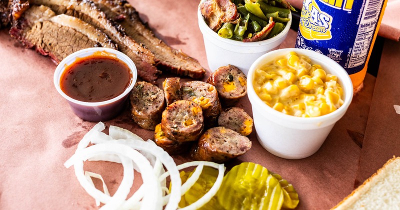 Brisket, jalapeno cheese sausage, pickles, onions, sauce, corn, green beans, and a soda