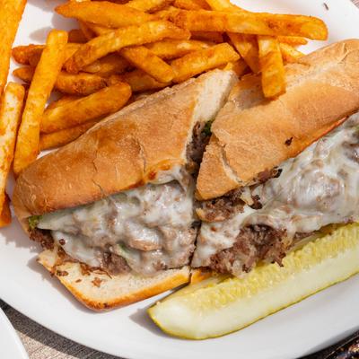 Steak and cheese sandwich with side fries