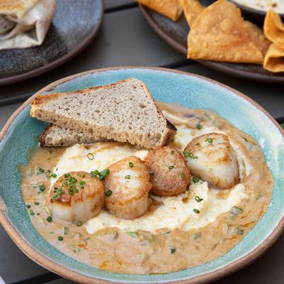 Grilled fish, sauce and snacks on the side