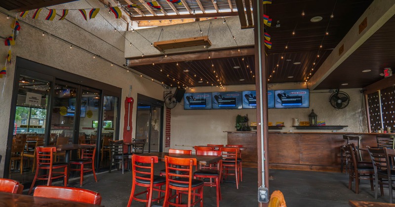 Interior, tables and chairs, TVs on the wall