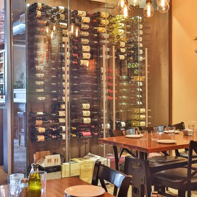 Glass wine rack in a dining room.