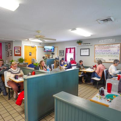 interior of dining room facing the back and specials board.